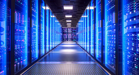 Server racks with flashing lights in a modern data center aisle