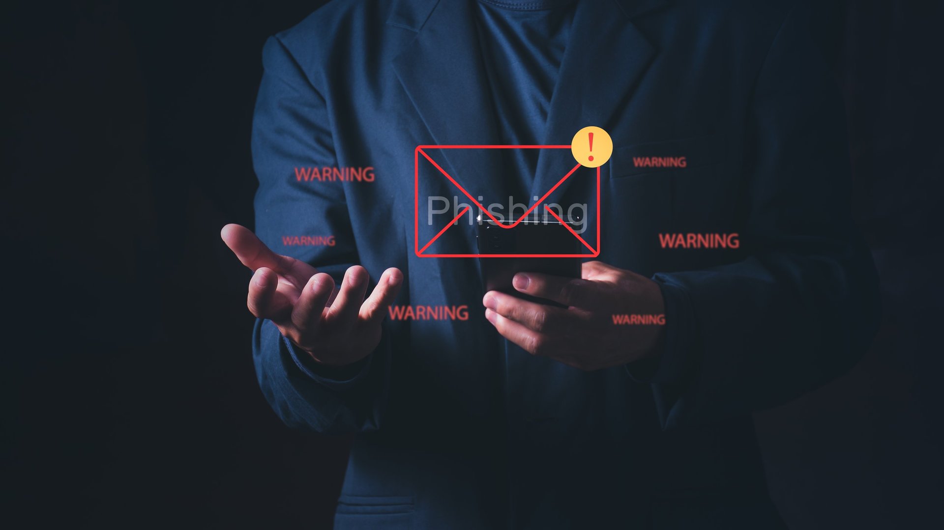 Businessman using smartphone with a phishing email and warning, Concept of cyber attack, identity theft, internet security alert, scam mail, and data protection from hackers.